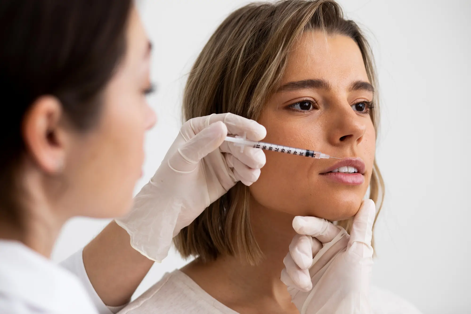 Beautiful woman getting lip filler close up Beautiful woman getting lip filler close up