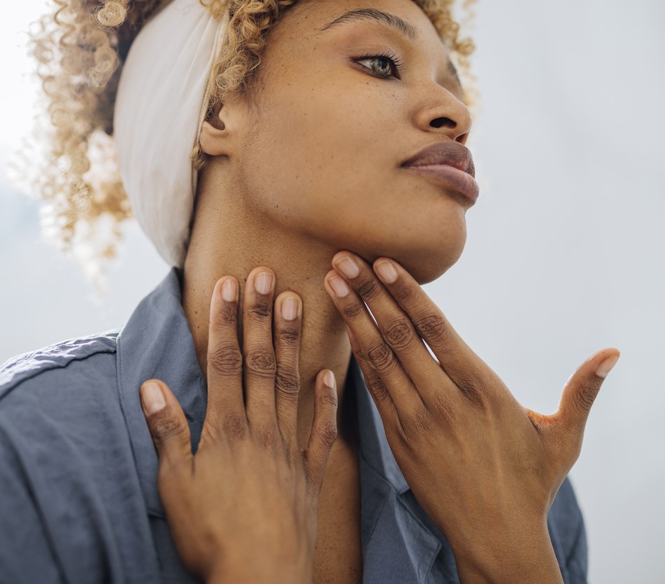 Woman touching muscle needing orofacial Myology in Mobile